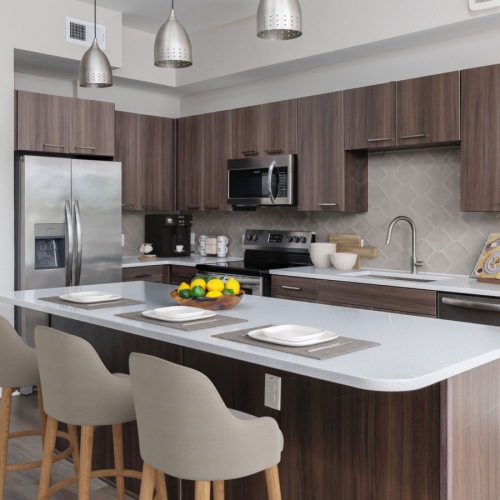 Kitchen island with pendant lighting and barstools