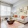 Grey couch in bright living room with large window. 